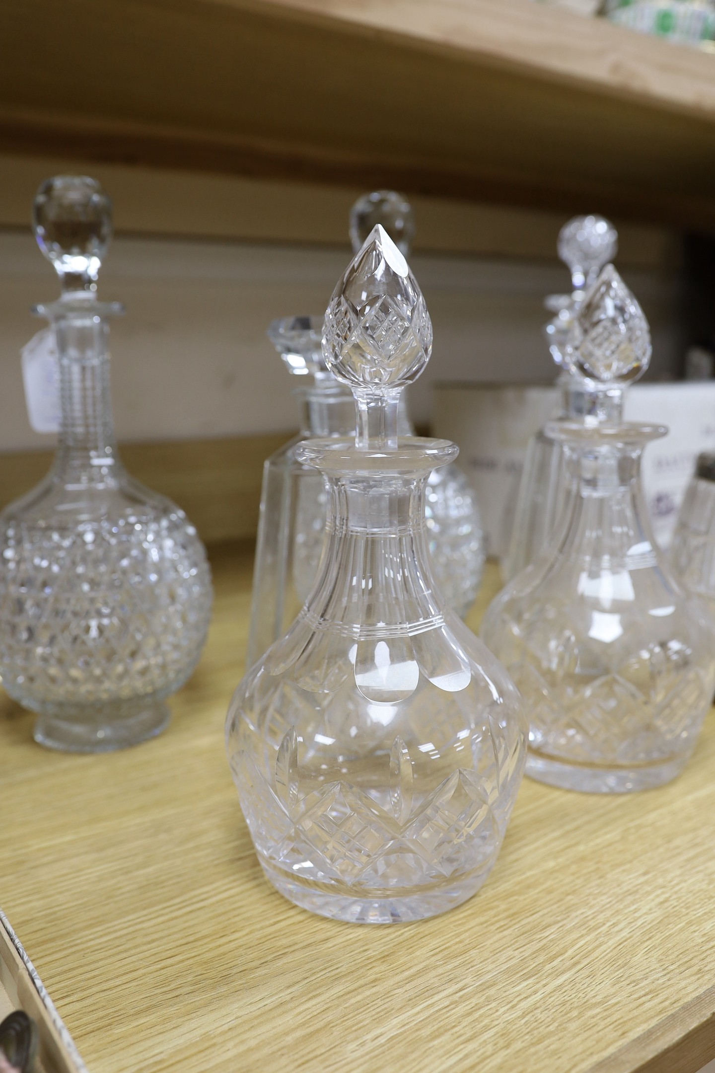 A pair of hobnail cut decanters two other pairs of cut glass decanters a single decanter and a glass and plate biscuit barrel